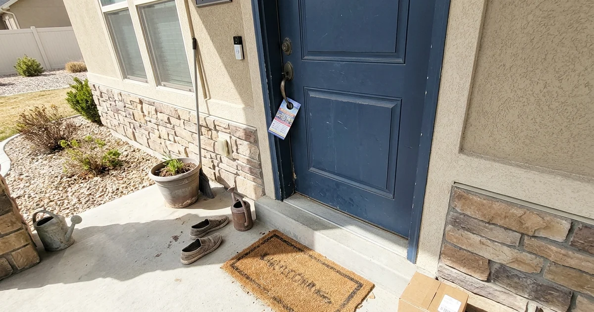 Door hanger on the front door handle of a suburban home