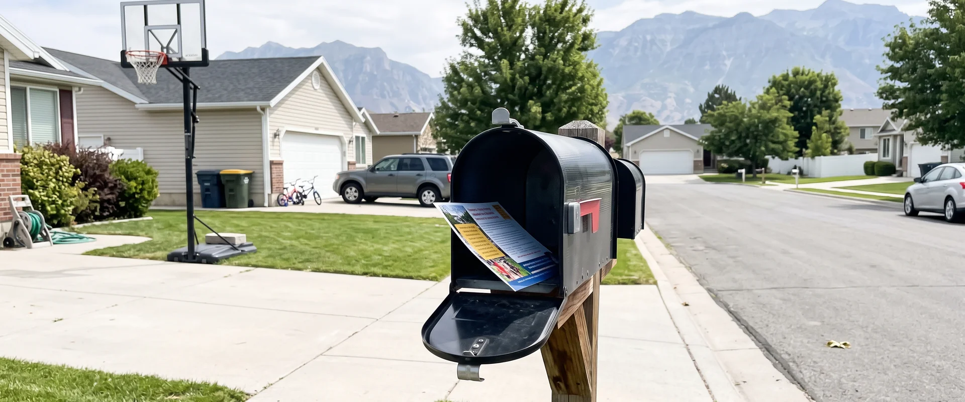 Oversized community postcard in a curbside mailbox on a Salt Lake Valley street