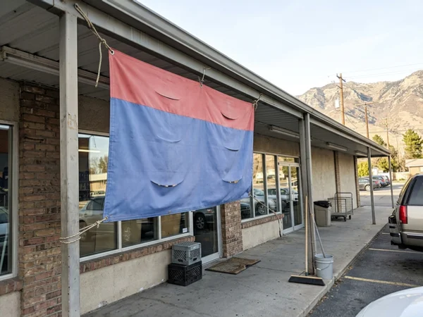 Banner with wind slits on a storefront