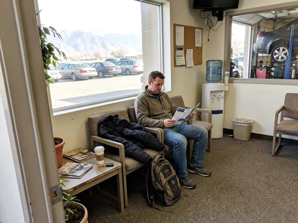 Customer reading a brochure in a waiting area