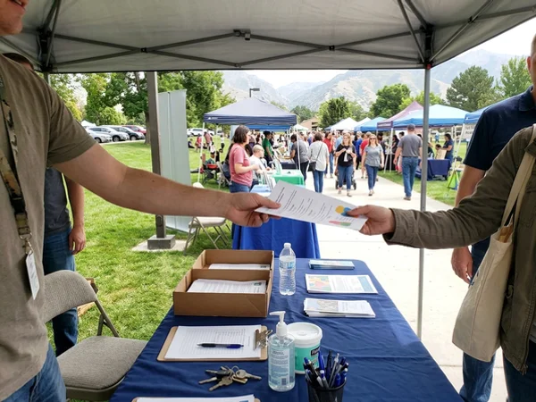 Handing out a flyer at a community event