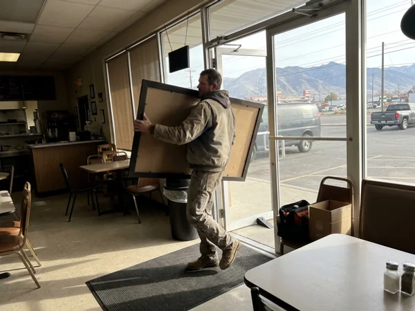Installer bringing a board into a restaurant