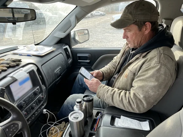 Owner catching up on texts between jobs