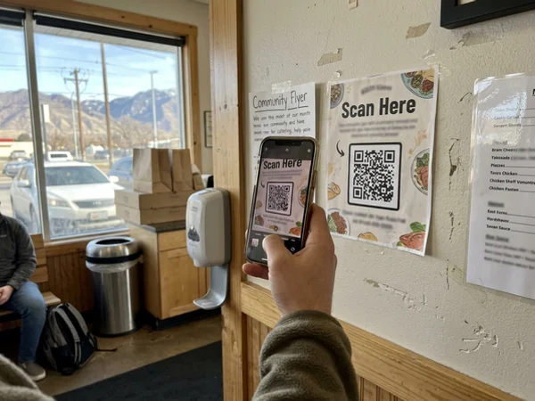 Scanning a board ad QR code while waiting for takeout