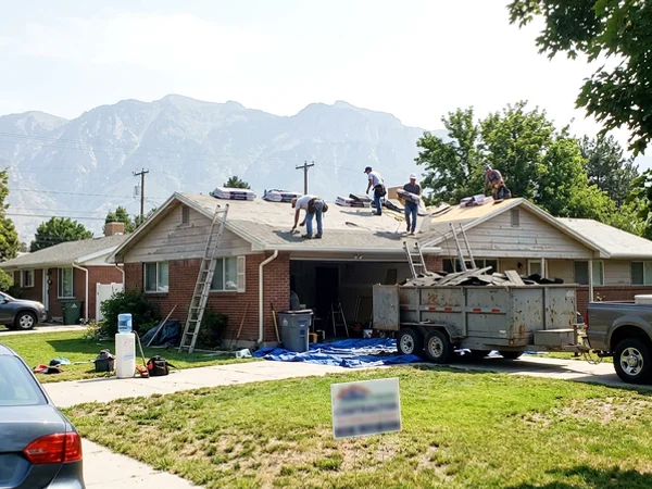 Job-site yard sign in front of a roofing project