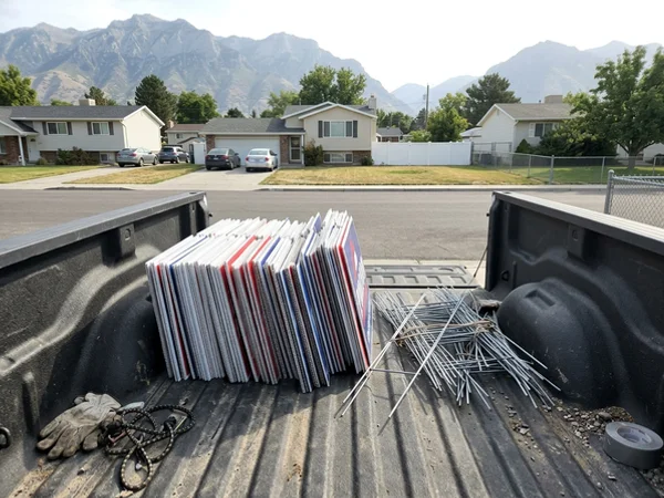 Yard signs and H-stakes in a truck bed