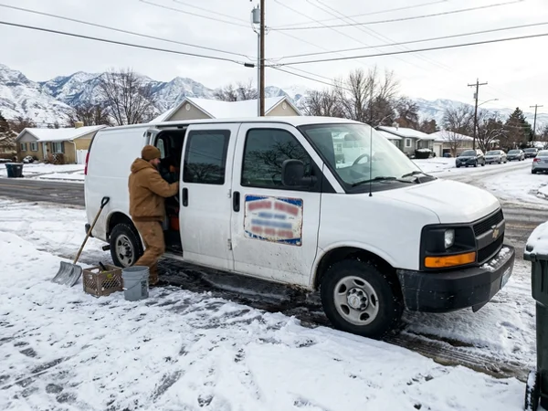 Van with a magnetic sign on a snowy street